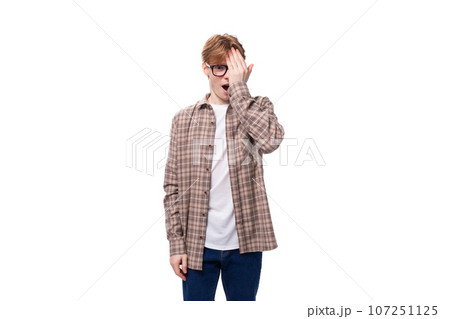 young stylish man with red hair with glasses on a white background 107251125