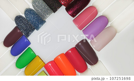 Palette of multi-colored nail polishes. Manicure and gel polish color choice. 107251698