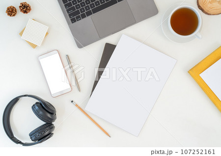 Top view above of white office desk table with keyboard computer, notebook and coffee cup with equipment other office supplies. business and lifestyle concept with blank copy space 107252161
