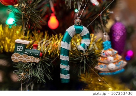 Wooden train, caramel cane. The concept of celebrating Christmas Wooden train, caramel cane. The concept of celebrating Christmas 107253436