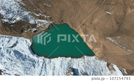 A mountain lake with emerald water is like mirror A mountain lake with emerald water is like mirror 107254793