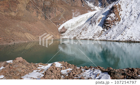 A mountain lake with emerald water is like mirror A mountain lake with emerald water is like mirror 107254797