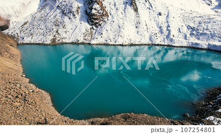 A mountain lake with blue water looks like mirror A mountain lake with blue water looks like mirror 107254801