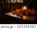 Autumn atmosphere, candles and autumn leaves on a wooden table 107256381