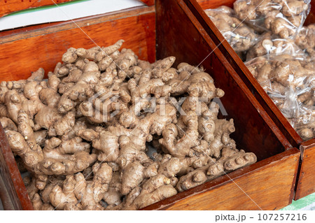 Heap of natural raw ginger is on a counter of local fruit market Heap of natural raw ginger is on a counter of local fruit market 107257216