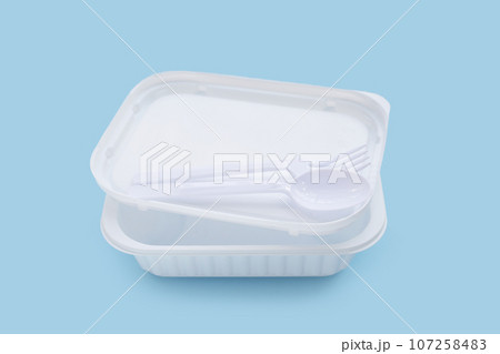 Plastic food boxes with spoon and fork on blue background. 107258483