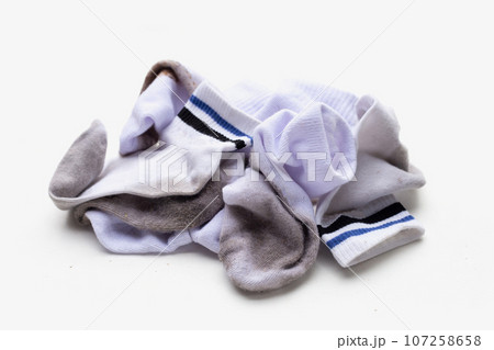 Dirty white socks on white background. 107258658