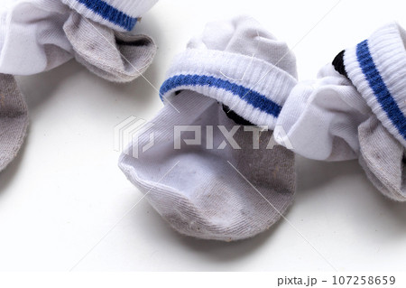 Dirty white socks on white background. 107258659