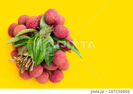 Lychee fruit on yellow background. 107258808
