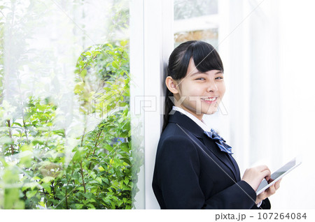 窓際でタブレットを持つ女子中学生　カメラ目線 107264084