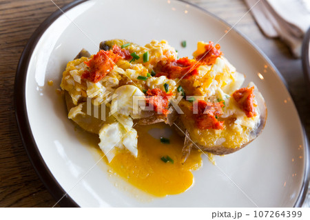 Potatoes al caliu with fried eggs and sobrassada Potatoes al caliu with fried eggs and sobrassada 107264399