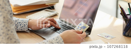 Female employee makes online payment for services on website 107268118