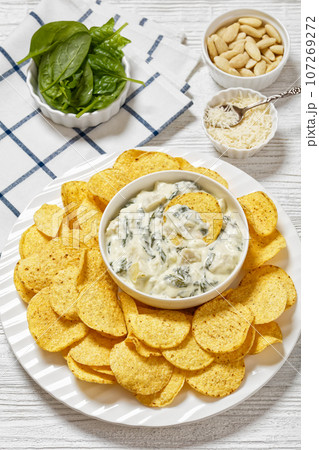 artichoke spinach almond dip with potato chips artichoke spinach almond dip with potato chips 107269272