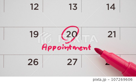Red color marker pen pointing at important appointment schedule on white calendar page date close up Red color marker pen pointing at important appointment schedule on white calendar page date close up 107269606