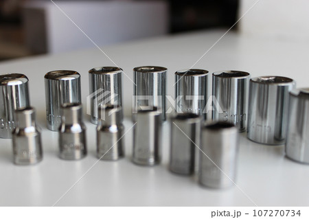 Ratchet Drive Sockets For Hex Nuts Arranged By Size On White Workbench  107270734