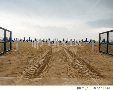 Wet sunbeds and umbrellas on the sea beach during rainy day. Wet sunbeds and umbrellas on the sea beach during rainy day. 107271138