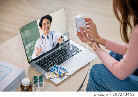 Telemedicine. Sick patient sit on sofa online consultation with doctor on laptop computer talking about illness and medication via video call at home, medical and health care technology online concept Telemedicine. Sick patient sit on sofa online consultation with doctor on laptop computer talking about illness and medication via video call at home, medical and health care technology online concept 107273455