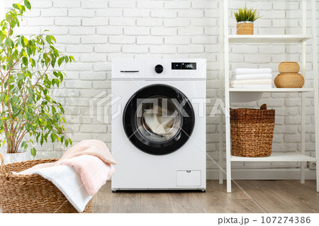 Modern white washing machine close up photo 107274386