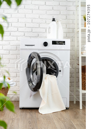 Detergent bottle on washing machine in a laundry room Detergent bottle on washing machine in a laundry room 107274395