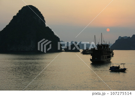 Junk ships in Ha long Bay at sunset Junk ships in Ha long Bay at sunset 107275514