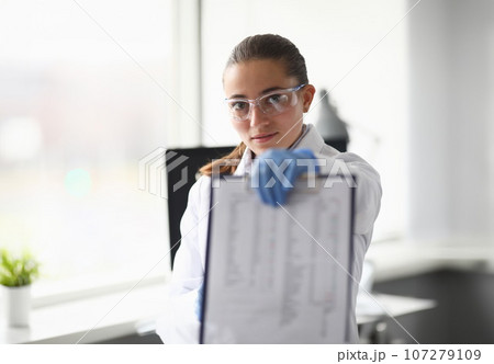 Woman in protective glasses 107279109