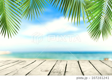 Empty wooden planks with beach, palms. Background for product, content placement 107281241