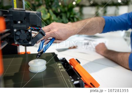 Engineers working with 3D printer process of printing. Engineers working with 3D printer process of printing. 107281355