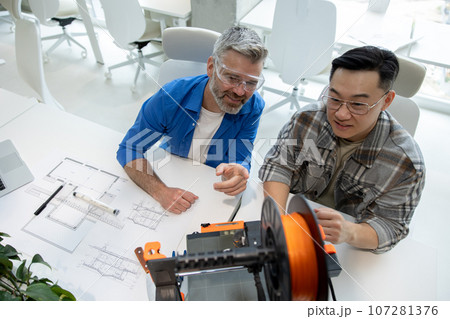 Scientists involved in setting up and developing 3D printers in the modern laboratory. 107281376