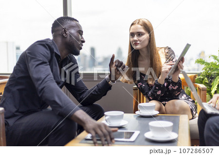 Happiness business team Colleagues talking talking and discuss in cafe during break in restaurant. 107286507