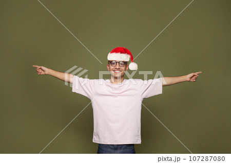 Christmas portrait of happy handsome young man Santa wearing empty t-shirt Christmas portrait of happy handsome young man Santa wearing empty t-shirt 107287080