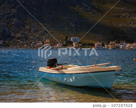View on Symi or Simi island harbor port, classical ship yachts, houses on island hills, Aegean Sea bay. Greece islands holidays vacation travel tours from Rhodos island. Symi, Greece, Dodecanese. 107287828