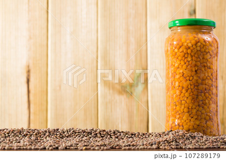 Glass jar with canned lentils 107289179