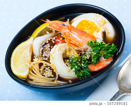 Asian cuisine spicy soup with squid 107289181
