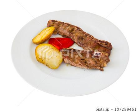 Tasty beef steak with baked potatoes served at plate, spanish dish Tasty beef steak with baked potatoes served at plate, spanish dish 107289461