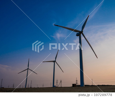 Windmills at sunset. Alternative energy source. Windmills at sunset. Alternative energy source. 107289778