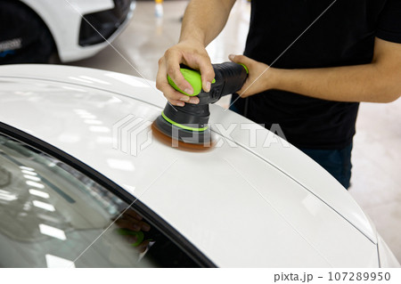 Professional worker applying special polishing paste and tool for car refreshment Professional worker applying special polishing paste and tool for car refreshment 107289950