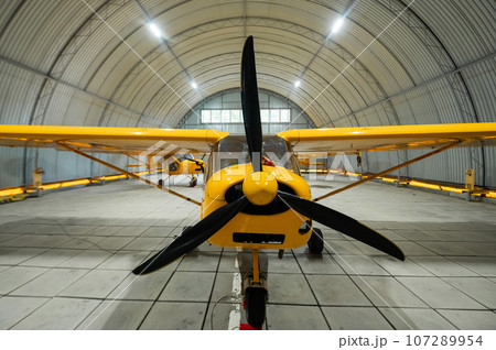 Yellow airplane glider in the hangar. Yellow airplane glider in the hangar. 107289954