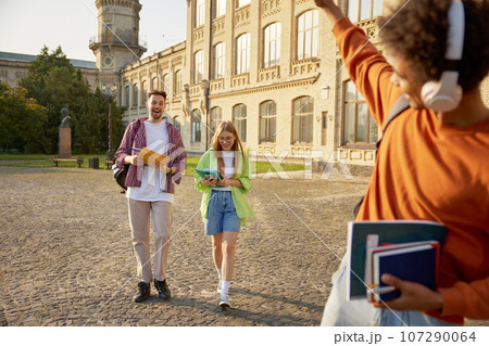 Multiracial group of students meeting at university campus during break 107290064