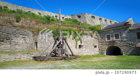 Kamyanets-Podilsky citadel tourism museum, Ukraine. 12 may 2023. Old wooden catapult in the courtyard of the castle Kamyanets-Podilsky citadel tourism museum, Ukraine. 12 may 2023. Old wooden catapult in the courtyard of the castle 107290973