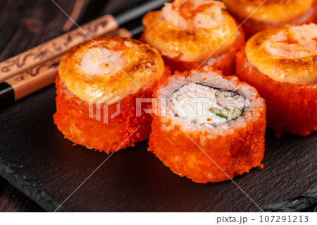 California sushi roll with crab cucumber and tobiko caviar served on black board close-up - Japanese asian food 107291213