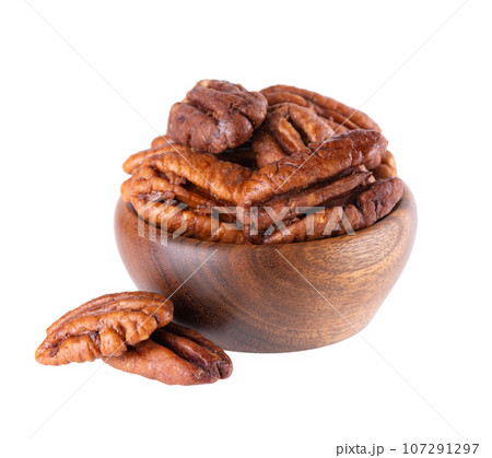 Pecan nuts in wooden bowl, isolated on white background. Shelled pecan. Clipping path. Pecan nuts in wooden bowl, isolated on white background. Shelled pecan. Clipping path. 107291297