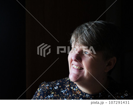 A middle aged lady looking off camera 107291431