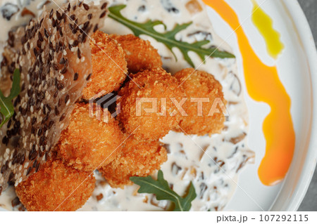 Potato croquettes - mashed potatoes balls breaded and deep fried, served with different sauce. Potato croquettes - mashed potatoes balls breaded and deep fried, served with different sauce. 107292115