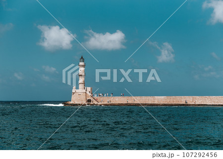 Chania harbour, Crete, Greece, showing Venetian lighthouse and tourists. 107292456