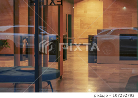 Building entrance, empty entrance inside, evening, blurry reflections in the glass. Lobby entrance with Turnstiles 107292792
