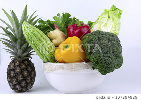 Vegetarian and vegan healthy lifestyle concept. Raw vegetables and fruits with empty plate over rustic background 107294929