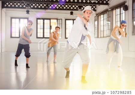 Group of young artists performing street dance Group of young artists performing street dance 107298285
