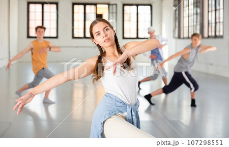 Group teenagers dancing hip-hop indoors Group teenagers dancing hip-hop indoors 107298551