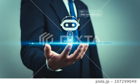 A businessman uses his hand to display a hologram of a robot or intelligent AI program, showing a Q&A chat with an artificial intelligence system, chatbot, AI assistant. A businessman uses his hand to display a hologram of a robot or intelligent AI program, showing a Q&A chat with an artificial intelligence system, chatbot, AI assistant. 107299049