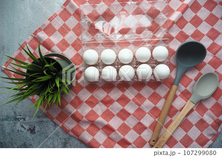 Eggs on the kitchen table.  107299080